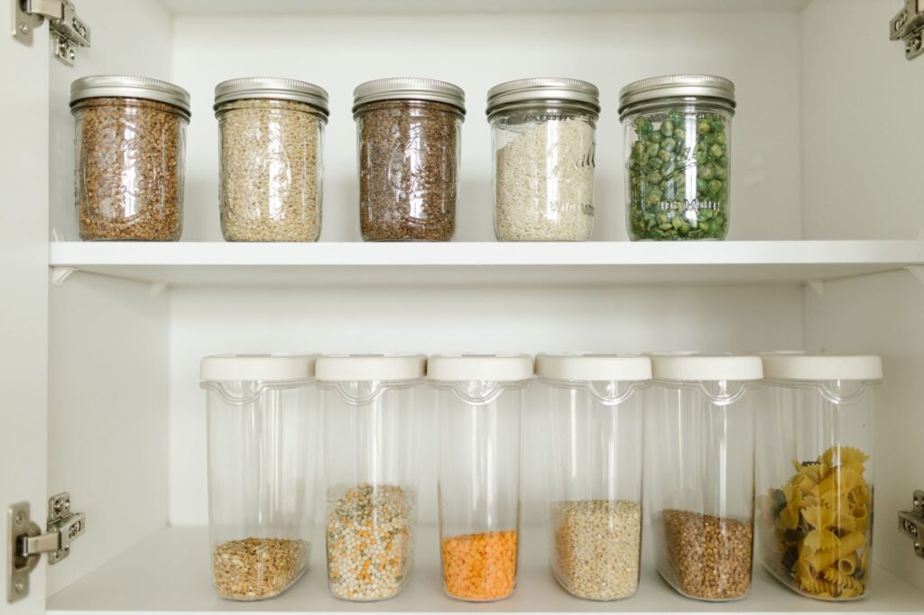 Budget-friendly pantry staples like rice, pasta, and canned goods stocked on a shelf