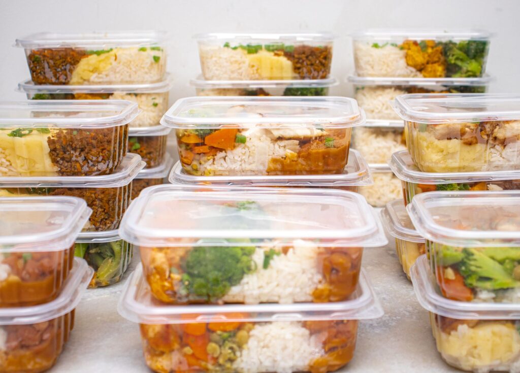 Batch-cooked meals portioned into single-serving containers ready for the freezer